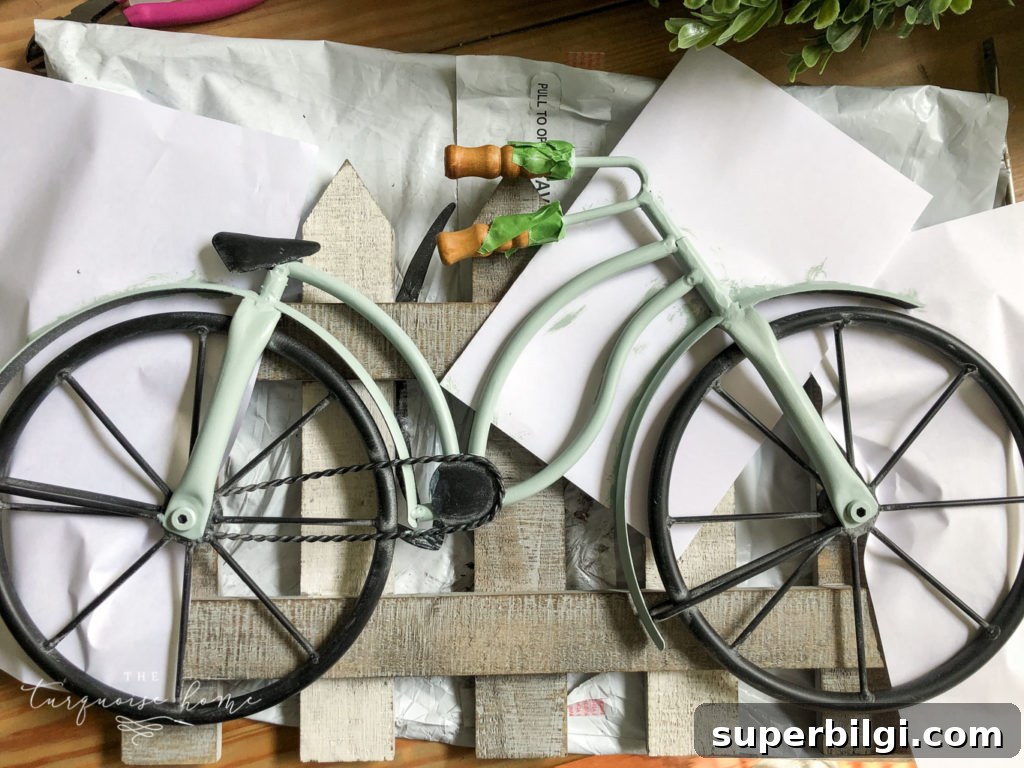 DIY Boxwood Bicycle Wheel Spring Wreath 4 DIY Boxwood and Bicycle Spring Wreath - use paper to protect your fence while painting the bike