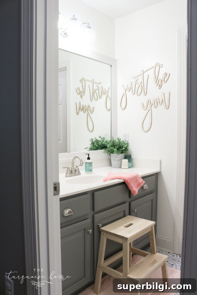 How to Create Big Style in a Small Bathroom | The Girls' Bathroom Refresh Reveal | Wooden Step Stool | Pink Towels | Gray painted cabinets