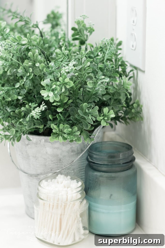How to Create Big Style in a Small Bathroom | The Girls' Bathroom Refresh Reveal | Boxwood in a Galvanized Bucket | Antique Candles 