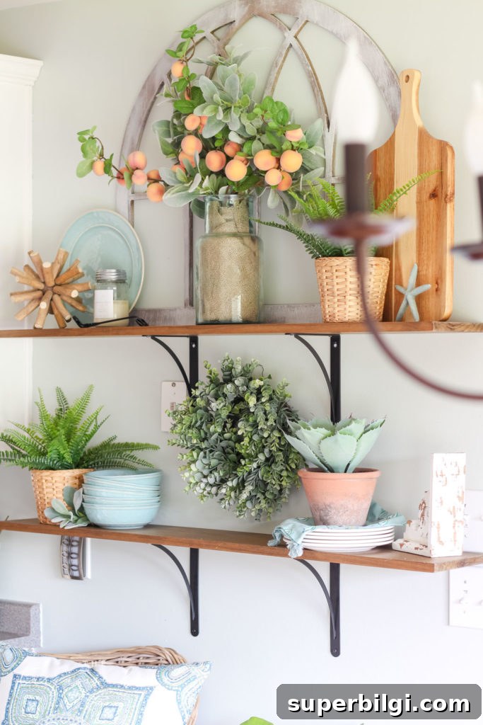 Peach-Inspired Summer Kitchen Decor 6 Open Kitchen Shelves Decorated for Summer - peach stems, turquoise dishes and lots of greenery