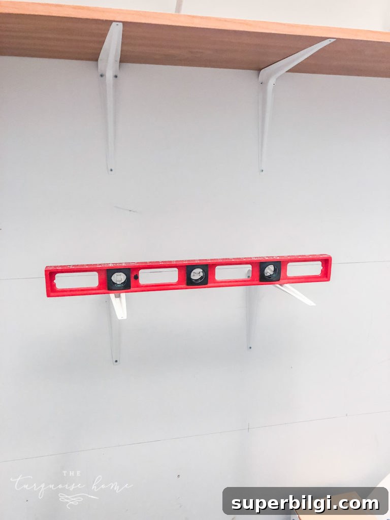 How to Build Closet Shelves: DIY Guide for Beginners 5 Use a level to keep the brackets straight when installing the pantry shelves.