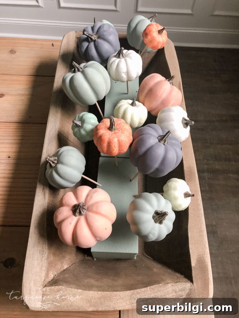 DIY Rustic Dough Bowl Centerpiece for Fall 5 Add the smallest pumpkins to the floral foam
