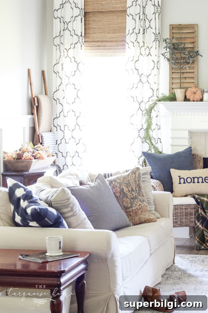 Neutral Fall Mantel Ideas for a Cozy, Timeless Look 6 Fall Living Room Decor with mantel with wood shutter decor and browns and blues.