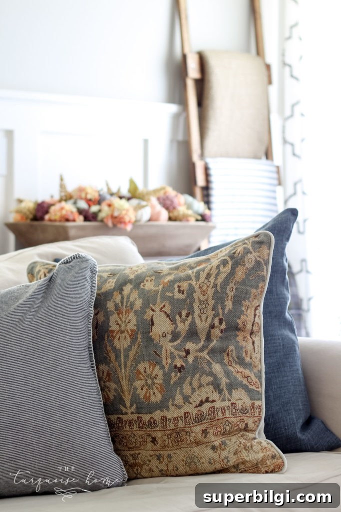 Neutral Fall Mantel Ideas for a Cozy, Timeless Look 7 Neutral fall decor with some small pops of jewel tones - bring a cozy, yet fun vibe to this fall living room decor.