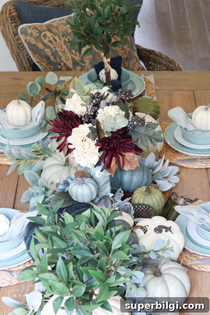Pumpkins and Greenery Fall Tablescape Ideas 2 Pumpkins and Greenery Fall Tablescape with bay leaves in a pot and fall floral arrangement.