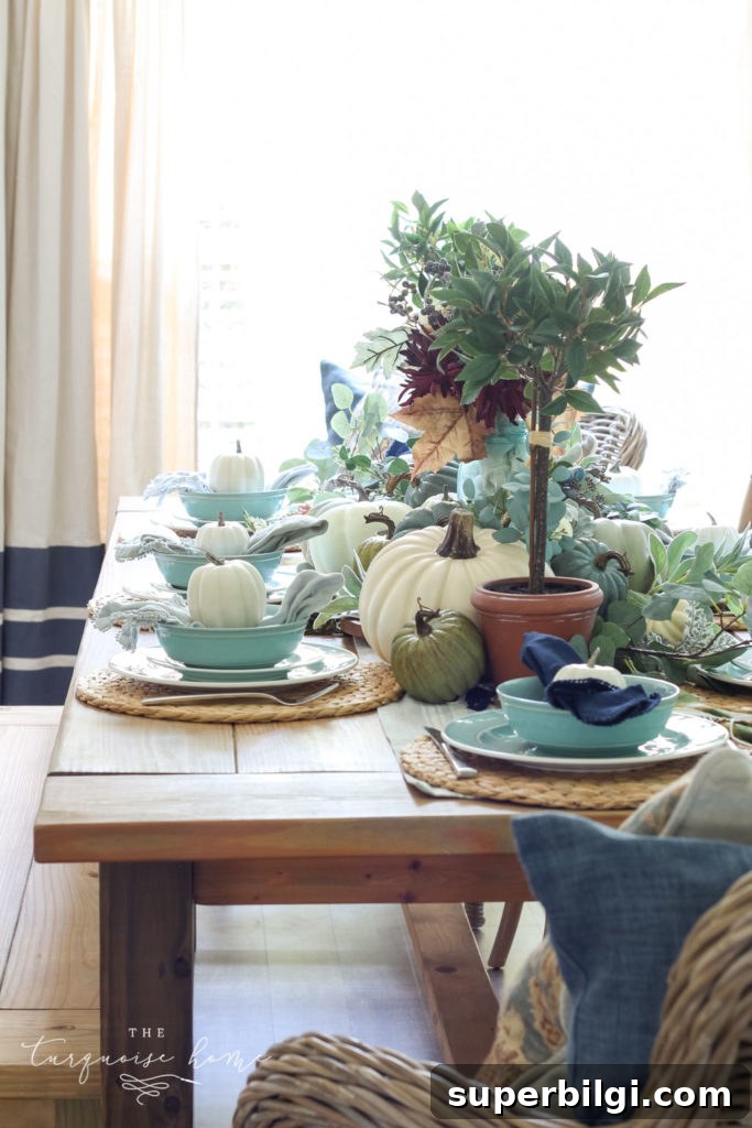 Pumpkins and Greenery Fall Tablescape Ideas 3 Pumpkins and Greenery Fall Tablescape with bay leaves in a pot and fall floral arrangement.