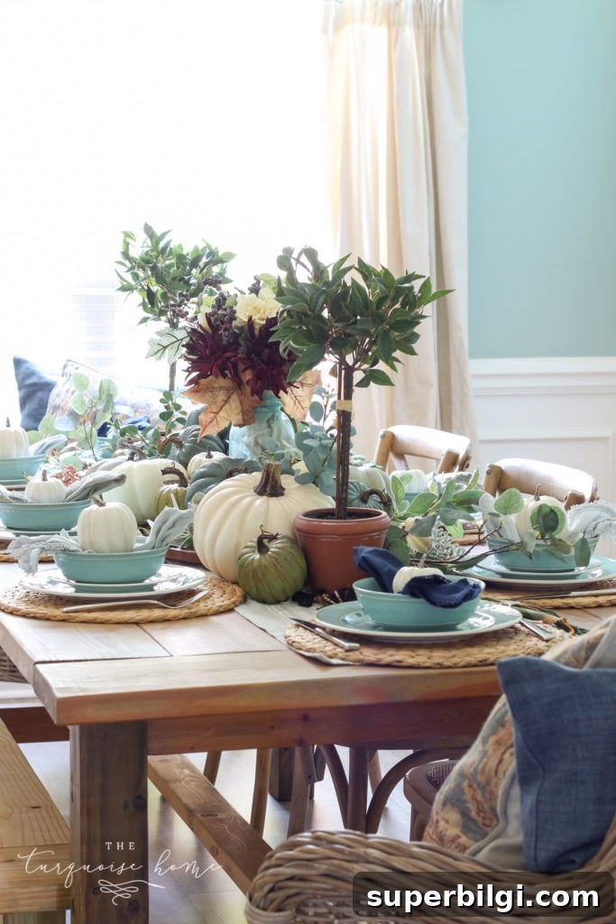 Pumpkins and Greenery Fall Tablescape Ideas 4 Pumpkins and Greenery Fall Tablescape with bay leaves in a pot and fall floral arrangement.
