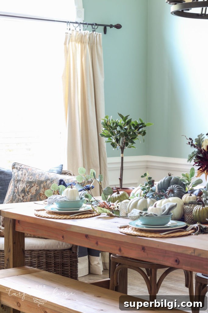 Pumpkins and Greenery Fall Tablescape Ideas 7 Pumpkins and Greenery Fall Tablescape with bay leaves in a pot and fall floral arrangement.