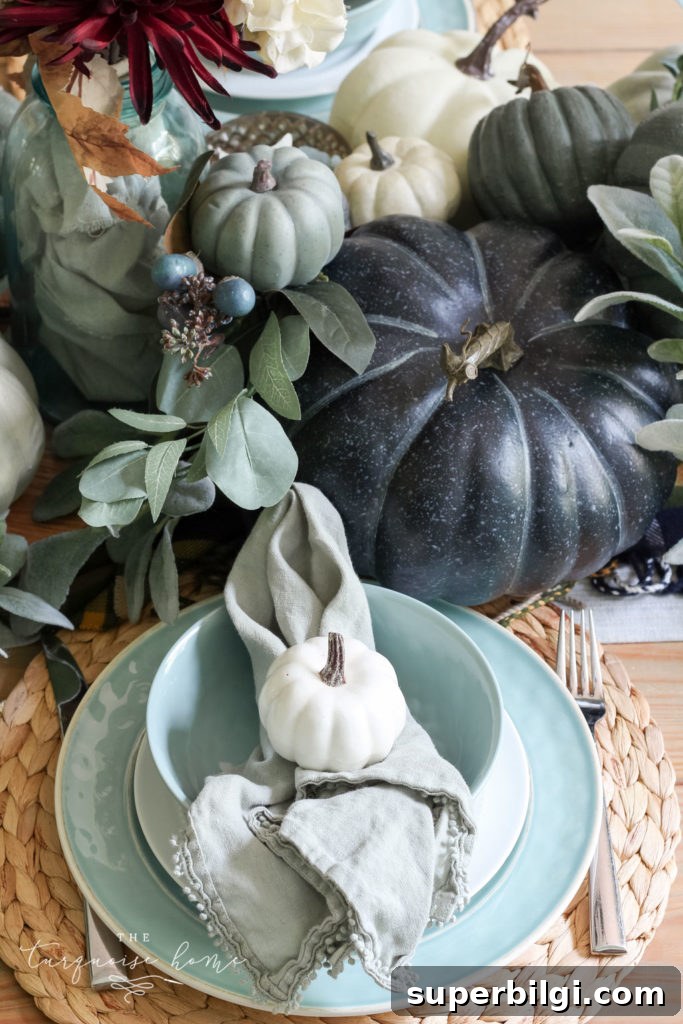 Pumpkins and Greenery Fall Tablescape Ideas 8 Pumpkins and Greenery Fall Tablescape with bay leaves in a pot and fall floral arrangement.