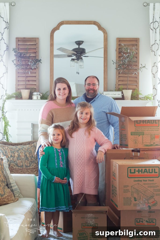 Why We're Moving: What Comes Next for Our Home 2 Family in front of fireplace with moving boxes