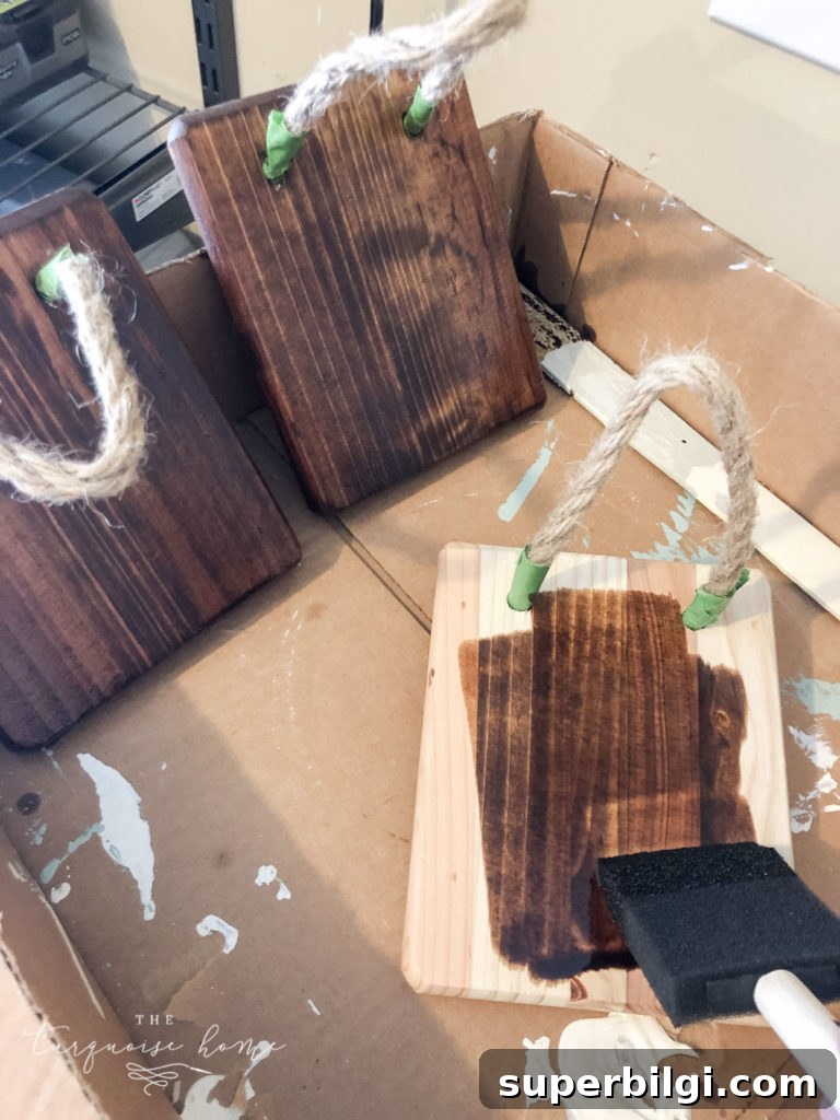 Staining the wood plaque for the twig ornament