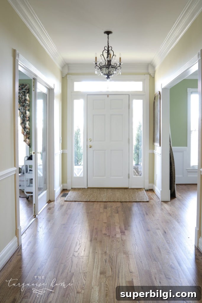 Our New Home Tour: Design, Layout and Renovation Details 12 Entry way in new house with brown hardwood floors.