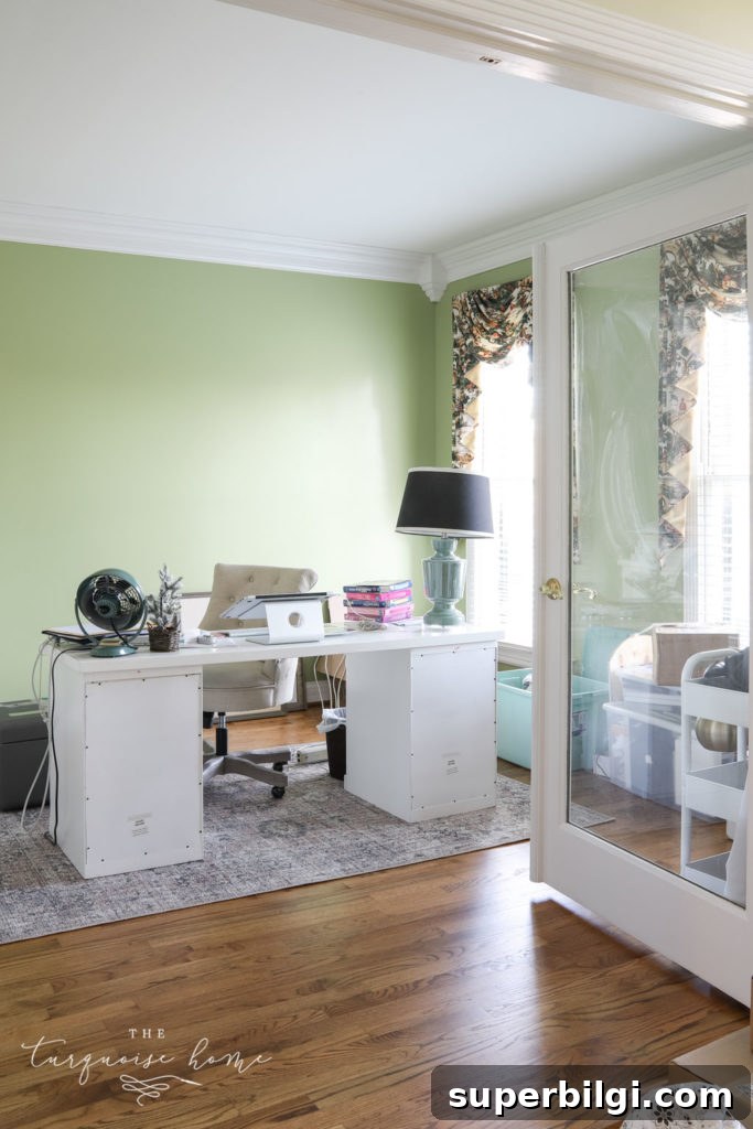 Our New Home Tour: Design, Layout and Renovation Details 13 Feminine office with lime green walls and desk in the middle of the room.