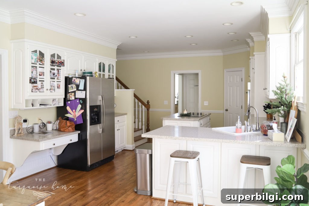 Our New Home Tour: Design, Layout and Renovation Details 4 Large kitchen with white cabinets and working island.