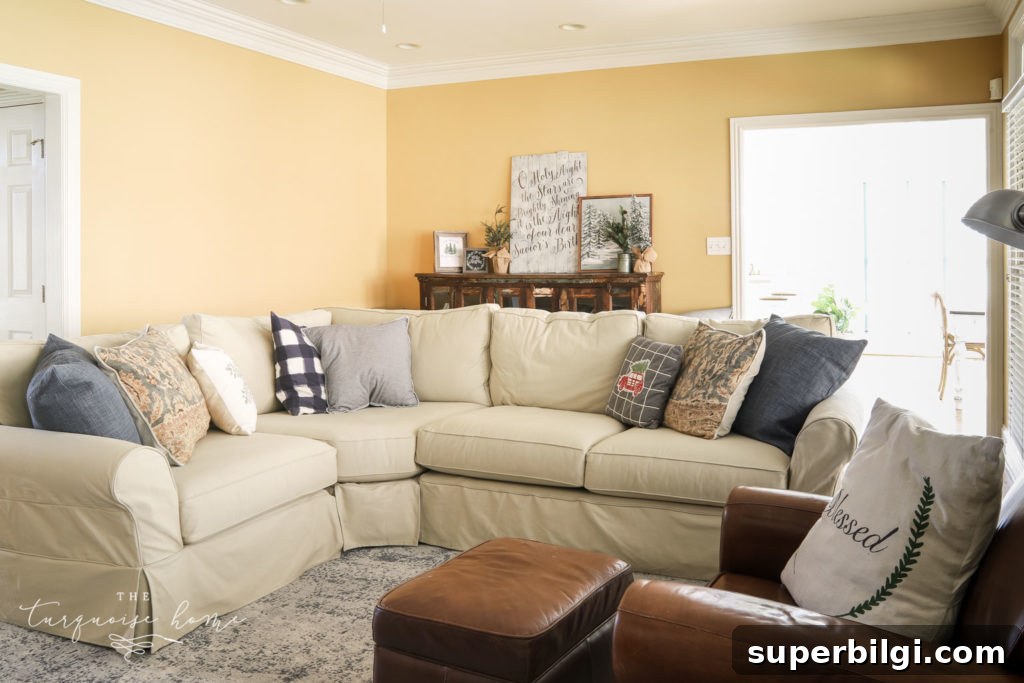 Navy Blue Living Room Mood Board and Color Palette 5 Buffet behind a sectional sofa with Christmas decor.