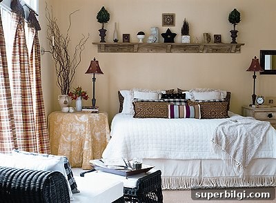 a shelf hangs above a bed with trinkets and objects on top