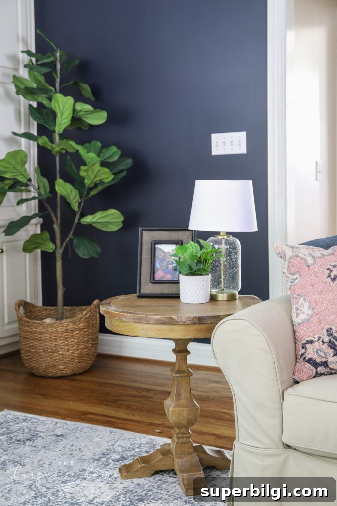 End Table Decor with a framed picture, potted plant and glass table lamp