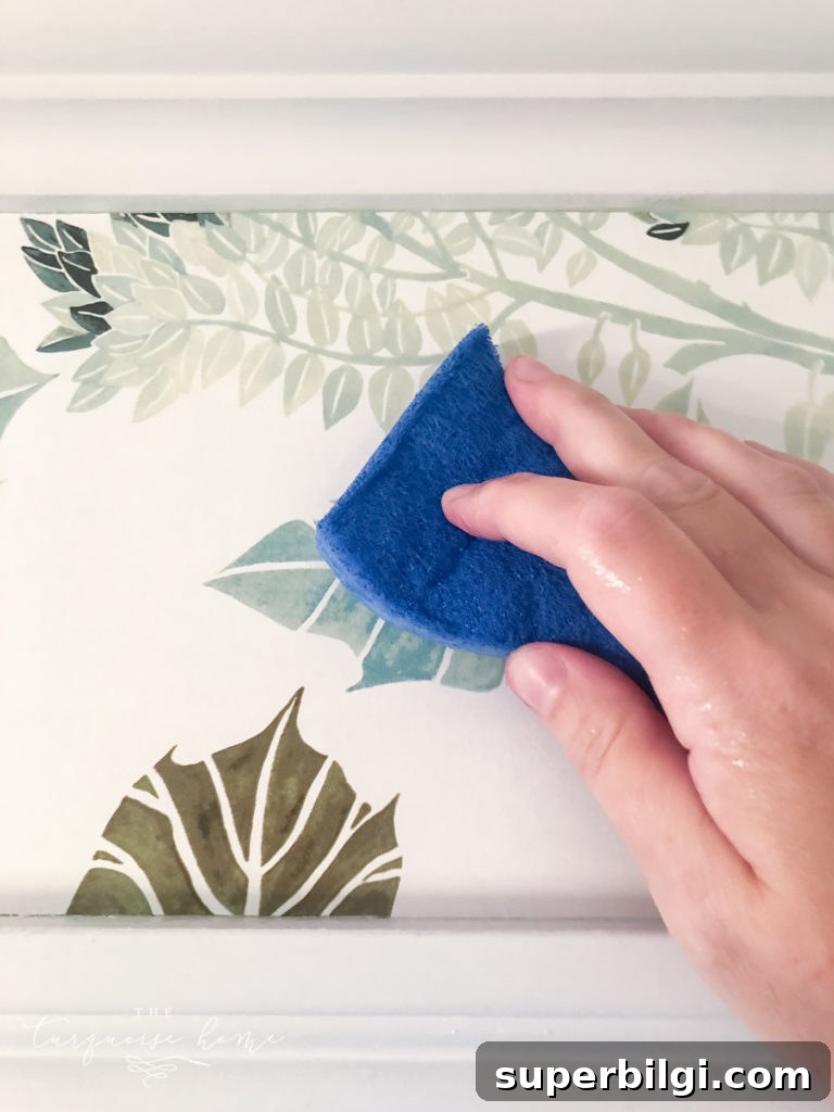 How to Hang Pre-Pasted Wallpaper: A Beginner's Guide 8 adhere wallpaper with damp sponge