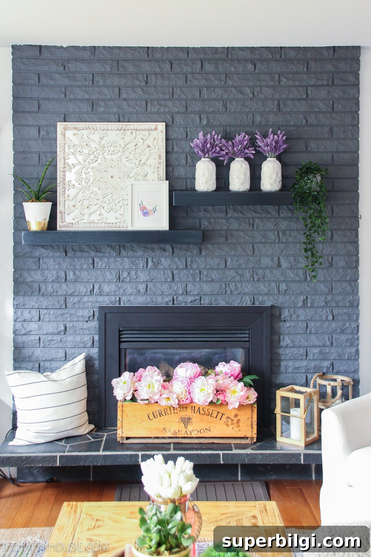 25 Spring Mantel Decor Ideas to Refresh Your Home 6 dark gray brick fireplace with spring flower blooms on mantel
