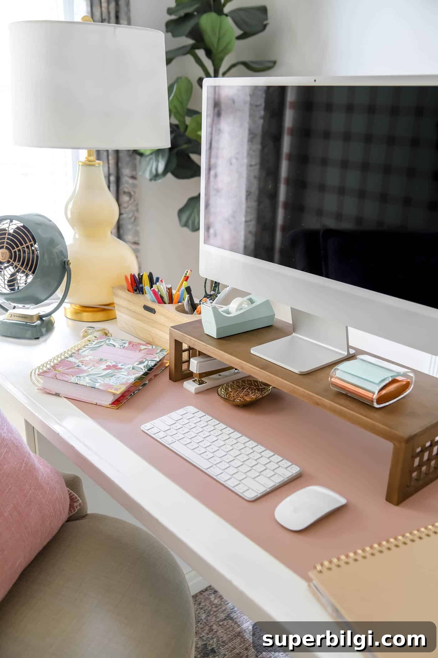 10 Office Decor Ideas to Transform Your Workspace 22 organized desk space with mac computer and desk riser, fan and lamp.