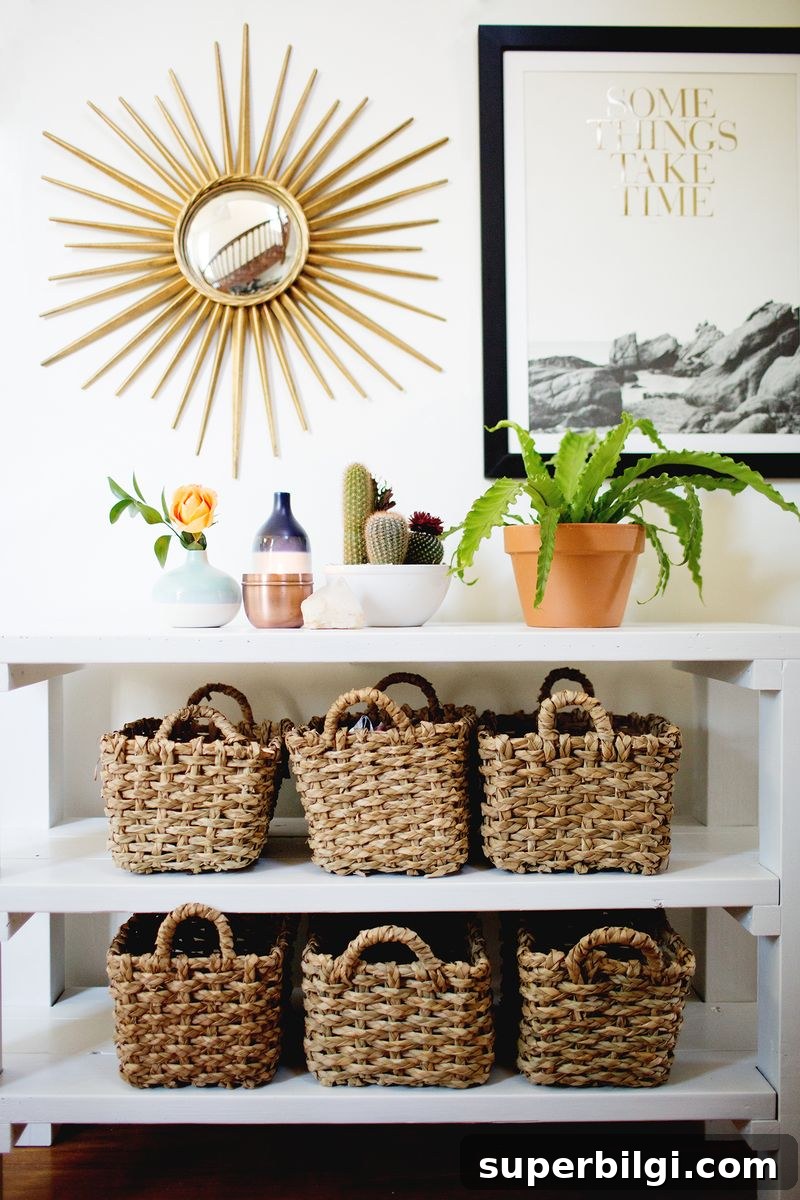 15 Space-Saving Storage Ideas for Small Entryways 9 Styled entryway with shelving unit, baskets and plants.