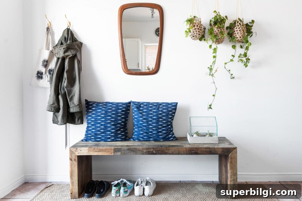 15 Space-Saving Storage Ideas for Small Entryways 13 Beautifully styled entryway with bench and hooks for hanging jackets and bags.