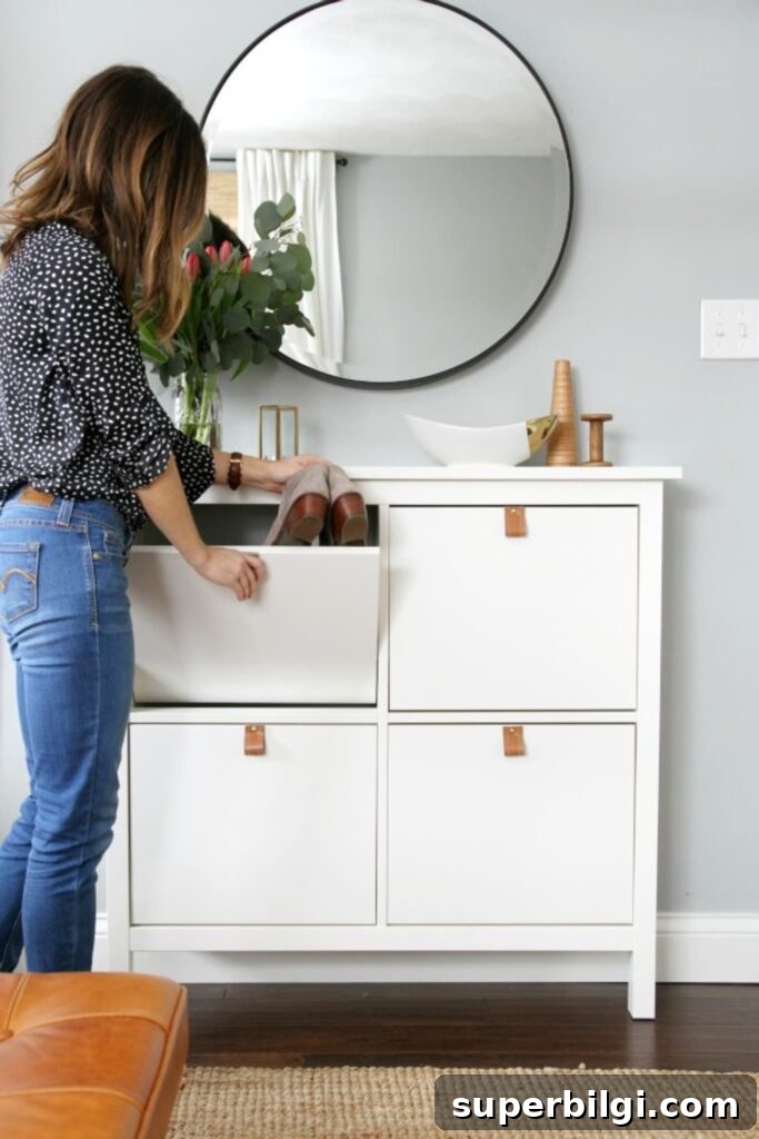 15 Space-Saving Storage Ideas for Small Entryways 14 IKEA shoe cabinet dressed up with leather pulls and a large round mirror.