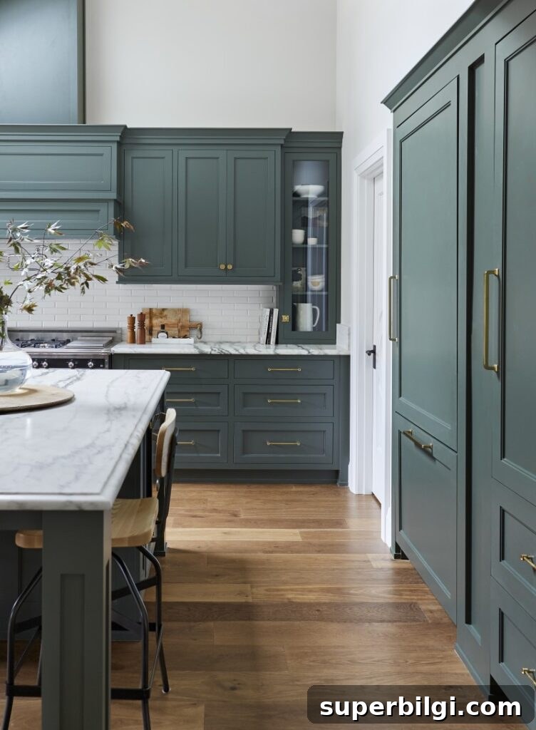 Green Paint Colors That Transform Your Home 16 Kitchen cabinets in Pewter Green by Sherwin Williams, paired with gold cabinet hardware.