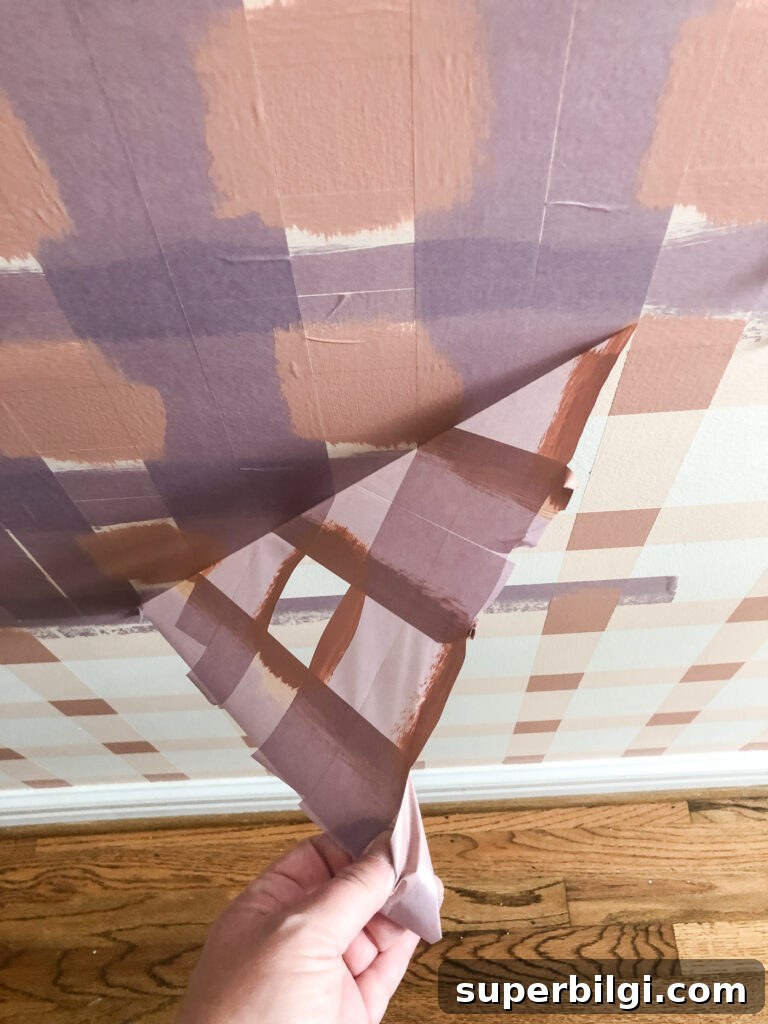 Step-by-Step DIY Plaid Accent Wall Tutorial 14 Remove tape on painted plaid wall