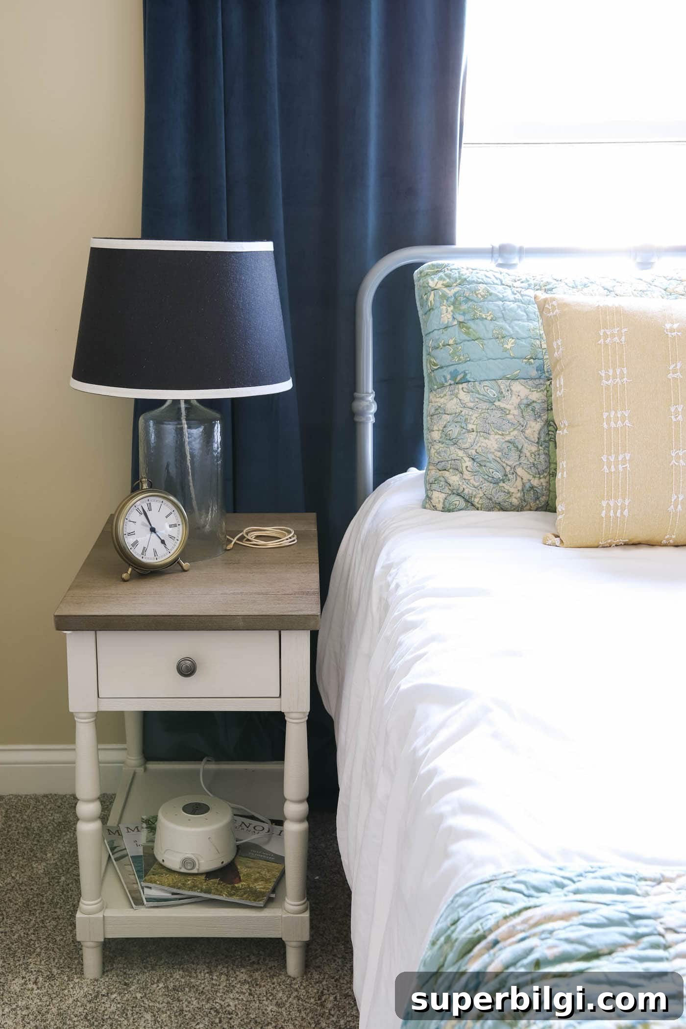 Guest Room Essentials to Make Visitors Feel at Home 10 clock, noise machine and lamp in guest bedroom