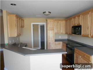 Paint Colors That Complement Oak Cabinets 3 beige kitchen with gray countertops from the 1990s.