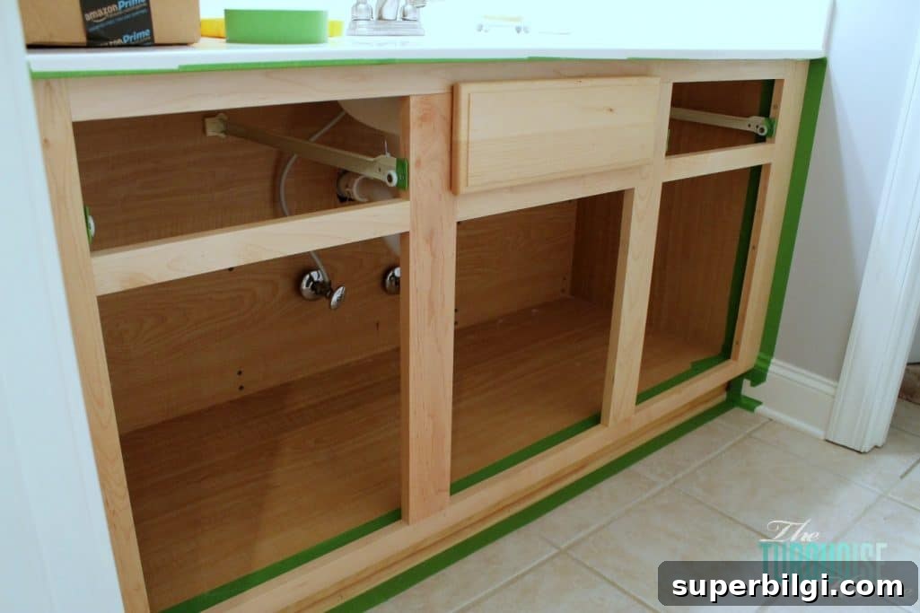 How to Paint Cabinets: Step-by-Step DIY Guide 7 When painting cabinets, tape off the walls and floors so you don't have to be precise! And you don't make a mess.