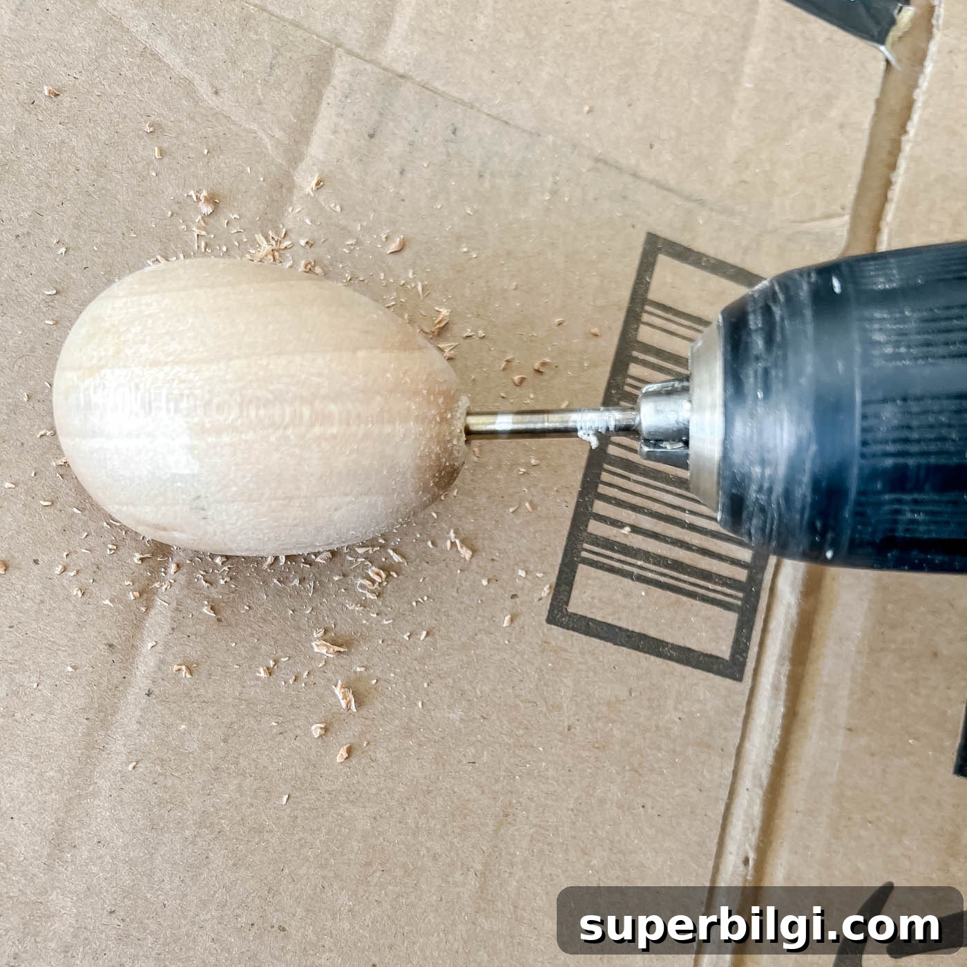 How to Make a Chinoiserie Egg Wreath for Spring Decor 3 Drilling a hole in a wooden egg