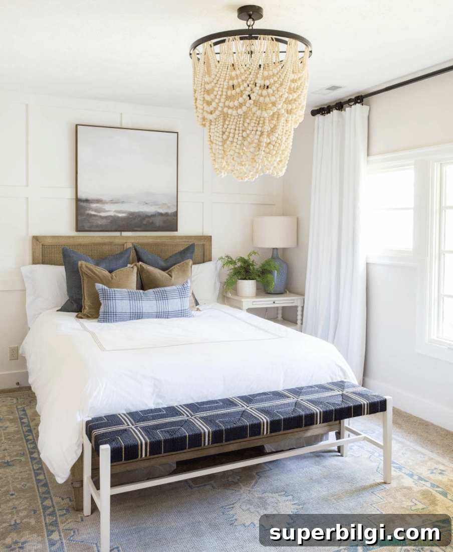 2026 Bedroom Paint Colors: 16 Shades for a Cozy, Relaxing Home 8 Swiss Coffee painted bedroom with white bedding and statement chandelier