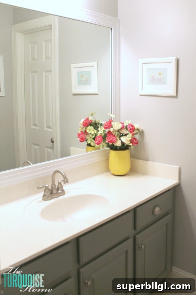 Frame a Builder-Grade Mirror: DIY Bathroom Upgrade 8 This simple DIY is easy and cheap! LOVE the custom look! | How to Frame a Builder-Grade Mirror | TheTurquoiseHome.com