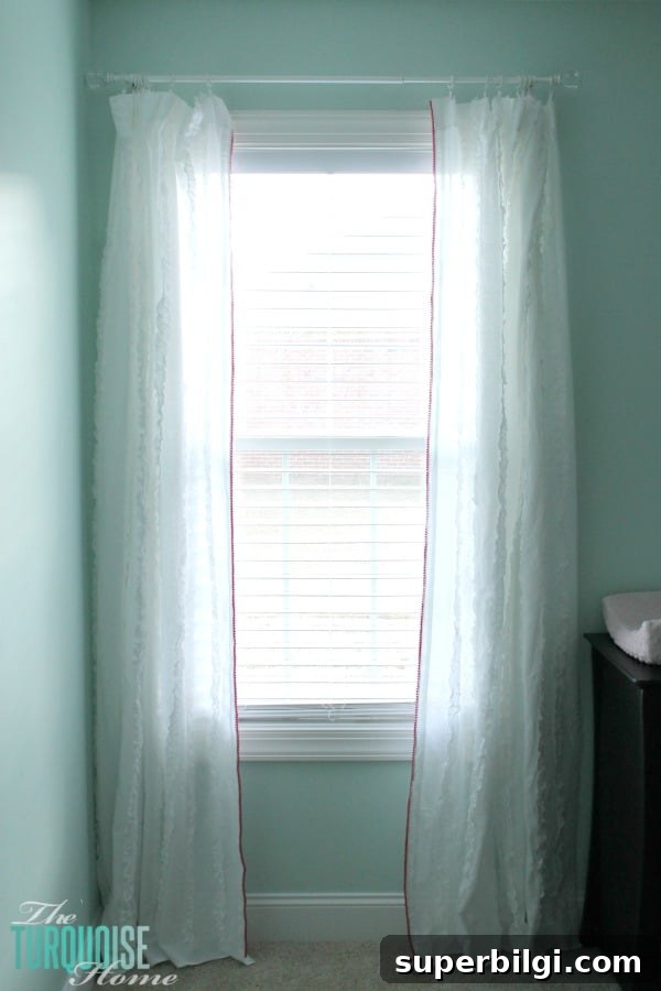 I love the little detail of the pom pom trim. And it's no-sew, my favorite!! Sweet Nursery Curtains with No-Sew Pom Pom Trim | TheTurquoiseHome.com