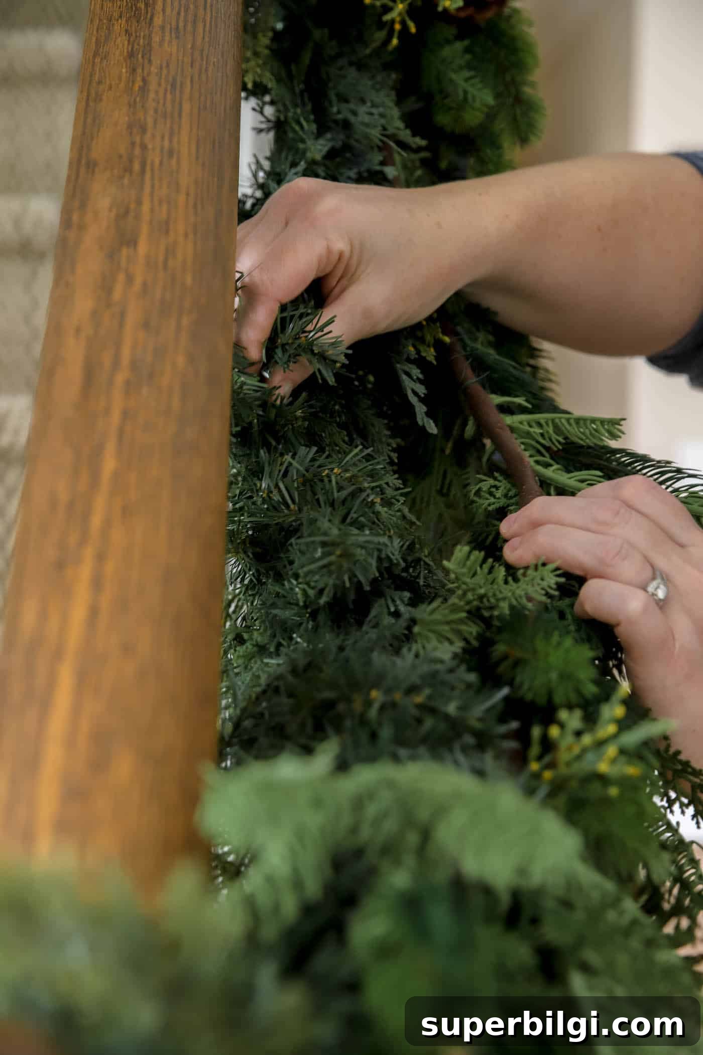 How to Hang Garland on a Staircase or Banister 7 attach second garland to first garland