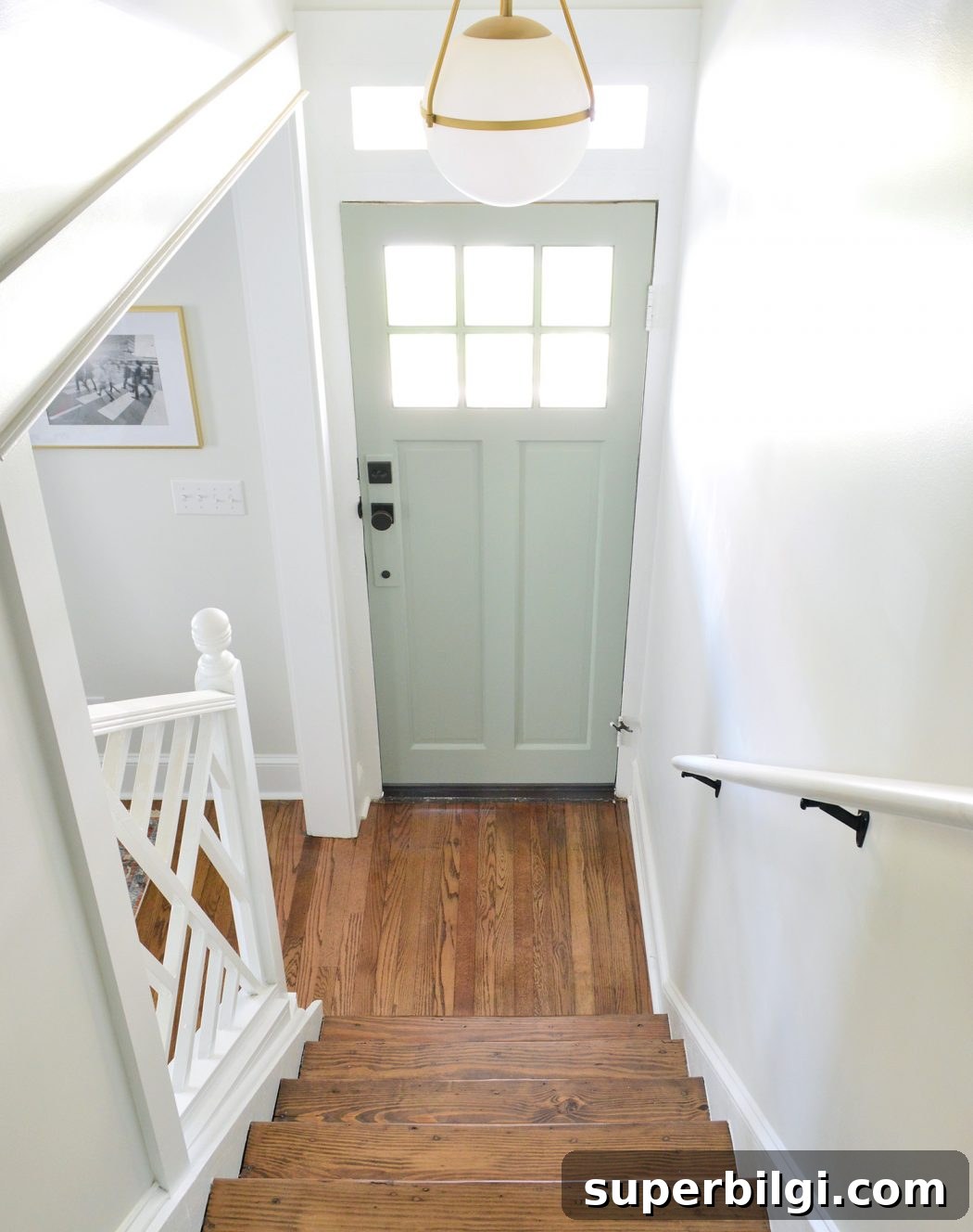 Light-filled entry way with front door painted Oyster Bay