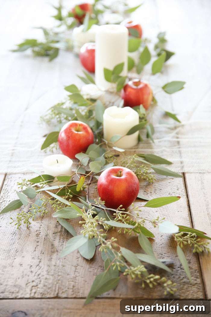 Stylish Fall Centerpiece Ideas for a Warm, Inviting Home 9 table centerpiece with apple, greenery, and candles.