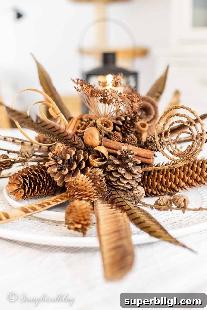 Stylish Fall Centerpiece Ideas for a Warm, Inviting Home 11 pinecones, cinnamon sticks, feathers, and florals in a fall centerpiece