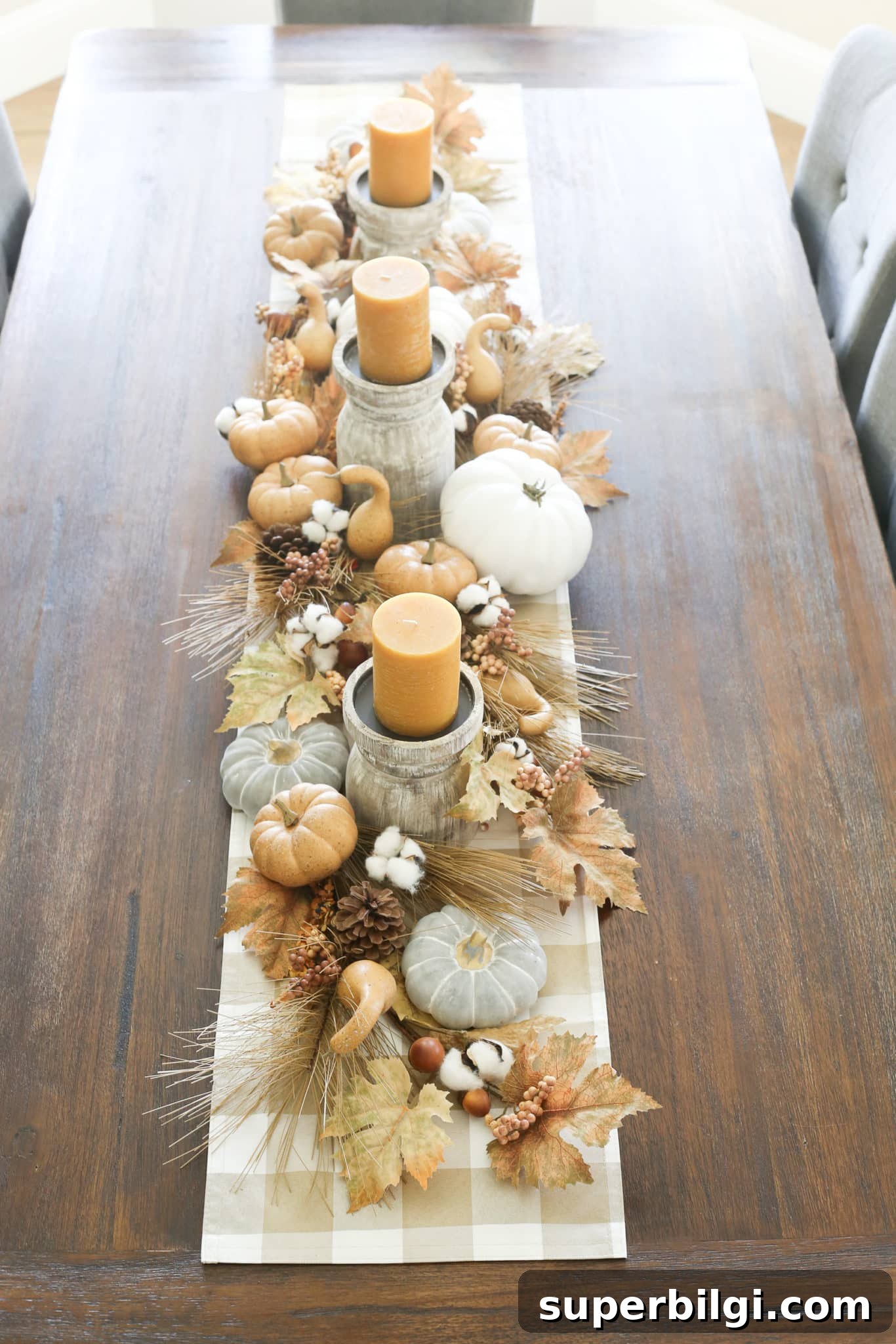Stylish Fall Centerpiece Ideas for a Warm, Inviting Home 15 fall tablescape with pumpkins, leaves, and candles.
