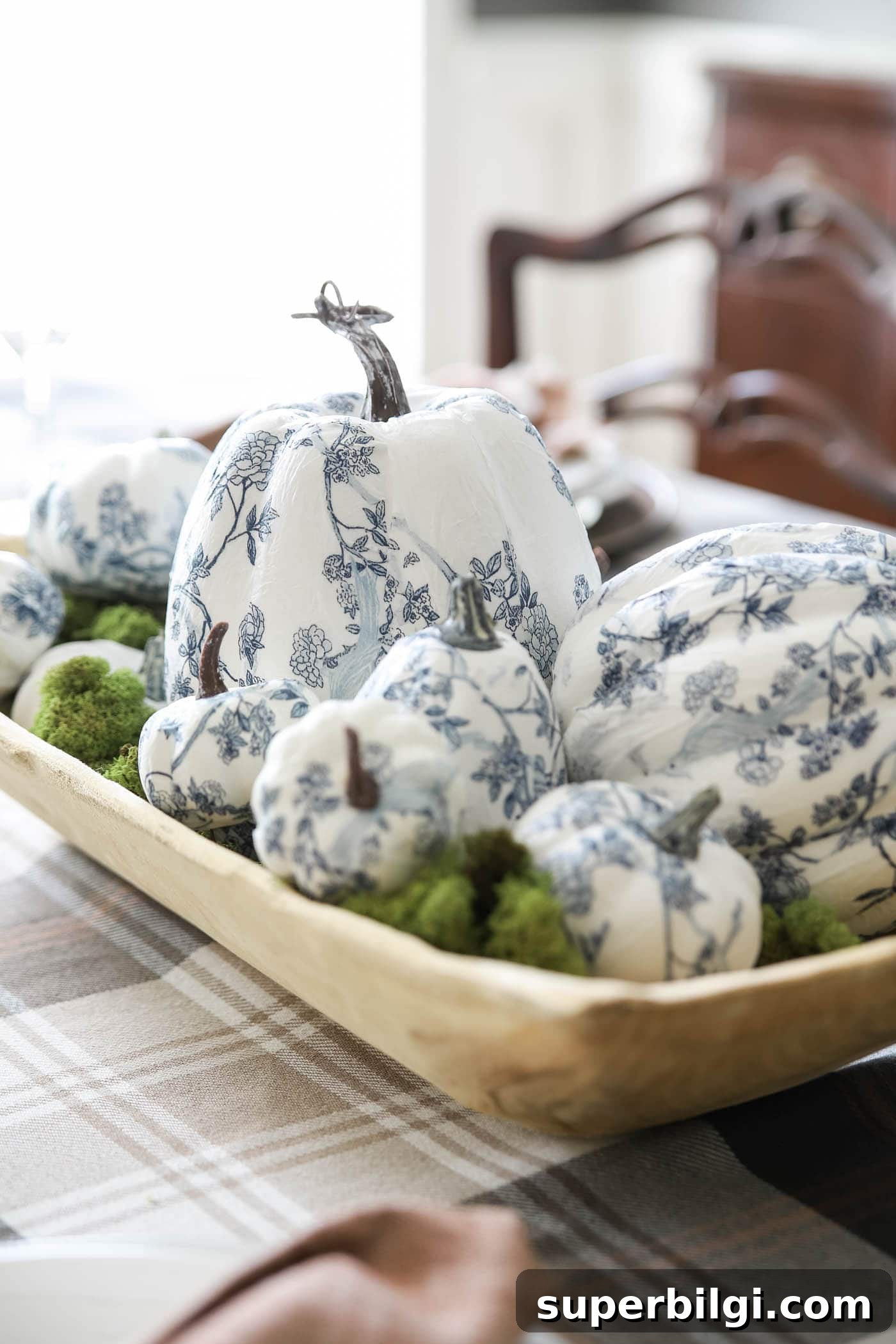 Stylish Fall Centerpiece Ideas for a Warm, Inviting Home 8 dough bowl filled with blue and white decoupaged pumpkins