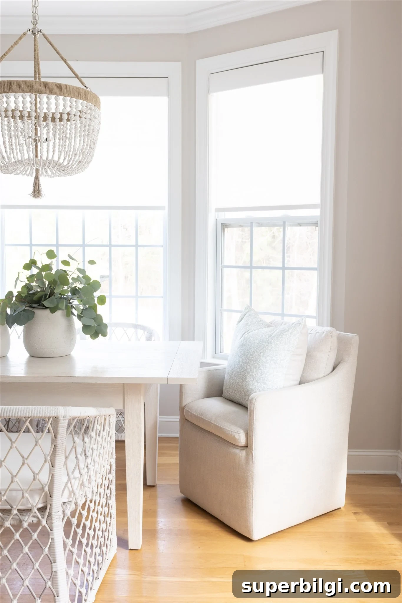 Benjamin Moore Balboa Mist: Soft Greige Paint Color 7 dining room with balboa mist walls, white trim, farmhouse decor and a chandelier