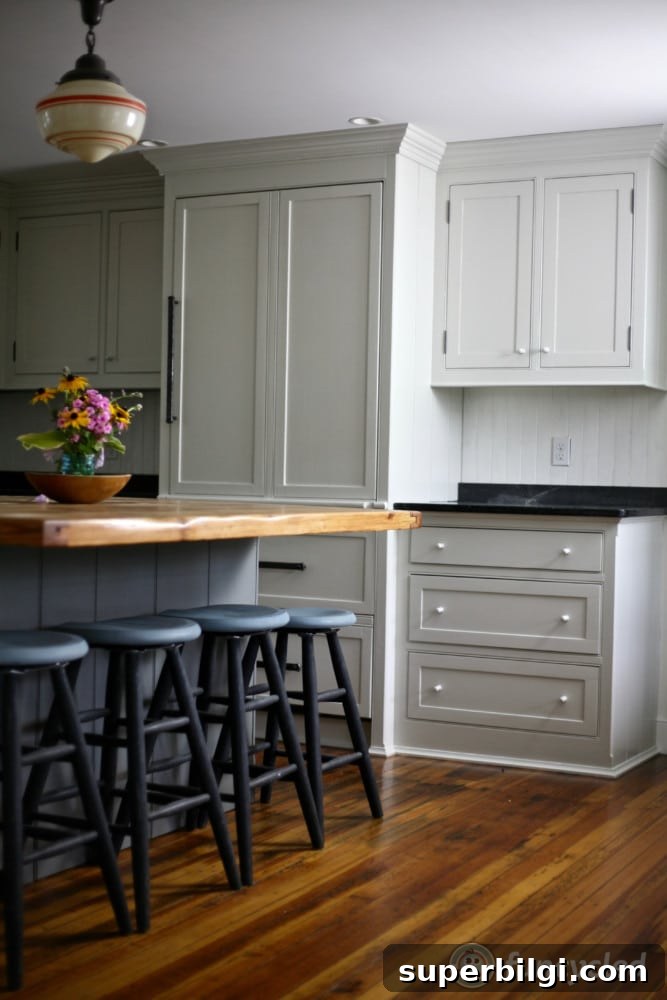 Benjamin Moore Stonington Gray Paint Color: Swatches & Hex Code 3 Benjamin Moore Stonington Gray kitchen cabinets paired with a darker gray island