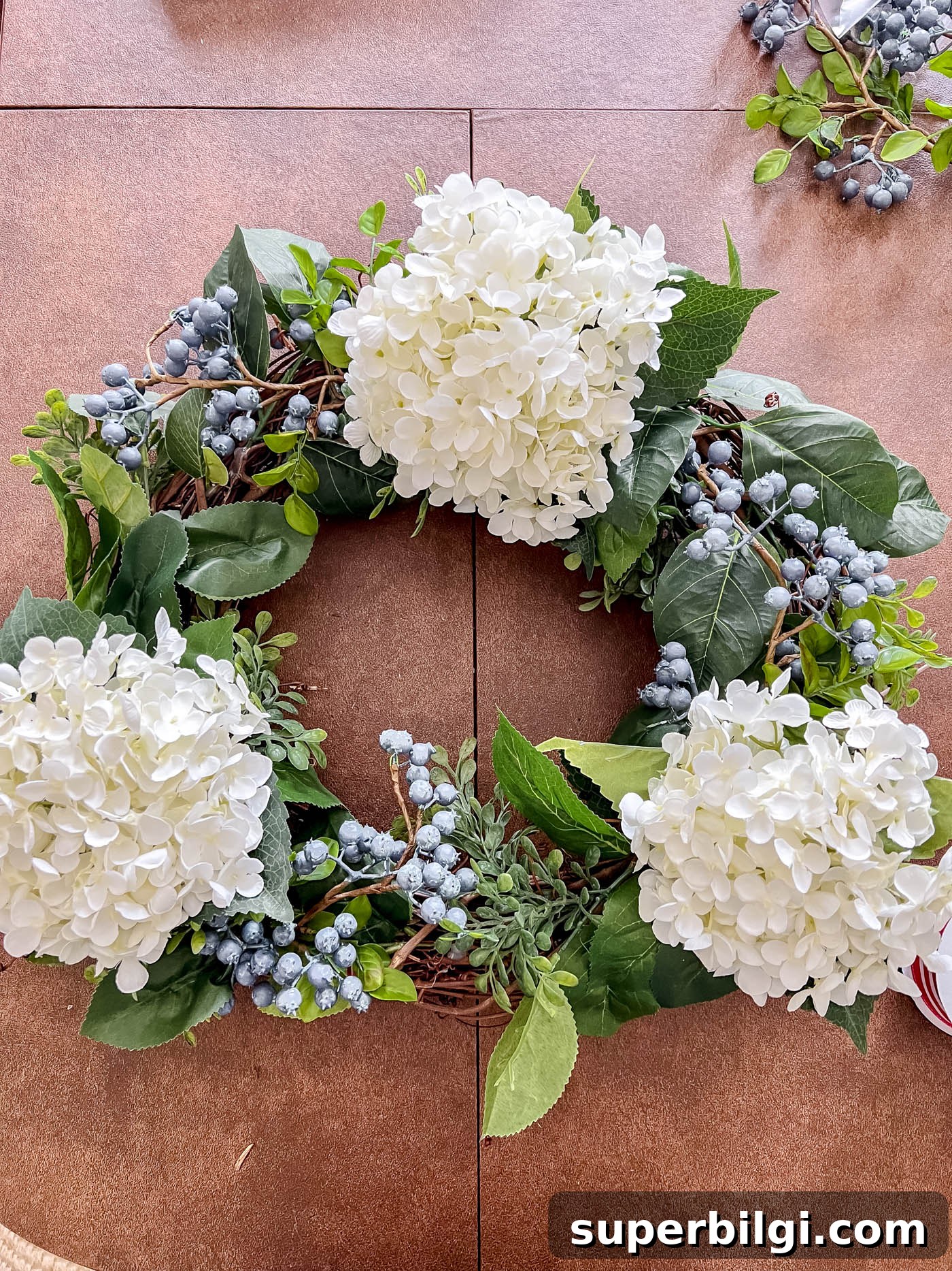 DIY Patriotic Wreath for Fourth of July & Memorial Day 6 Add blueberry stems to patriotic wreath
