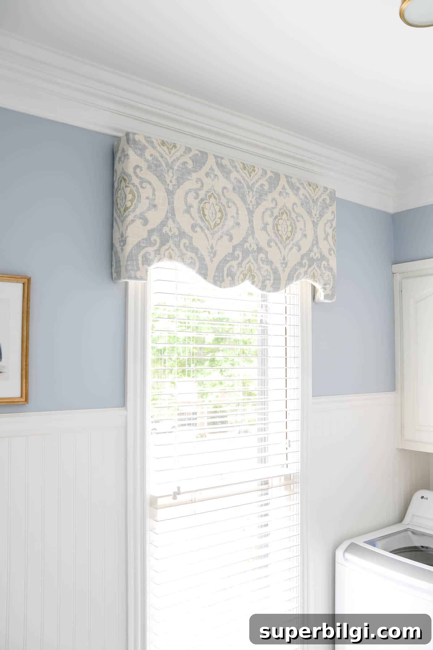 How to Make a Fabric Covered Cornice Board for Windows 6 cornice board over a window in a blue and white laundry room