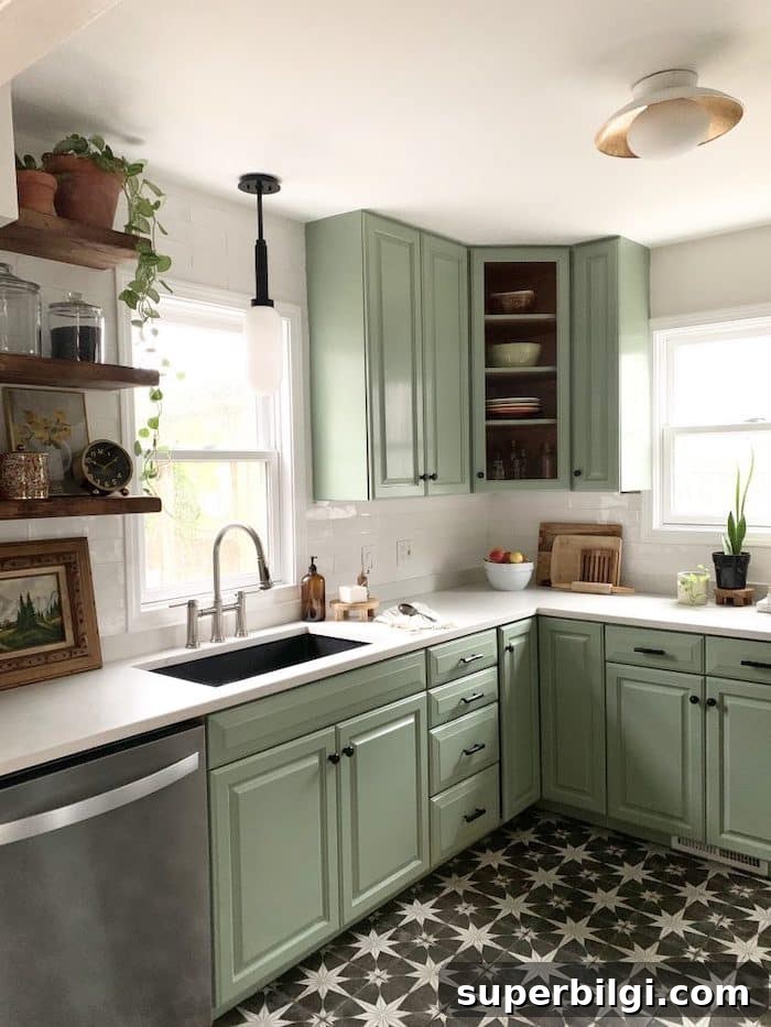 kitchen with white subway tiles and Behr Bitter Sage painted cabinets.