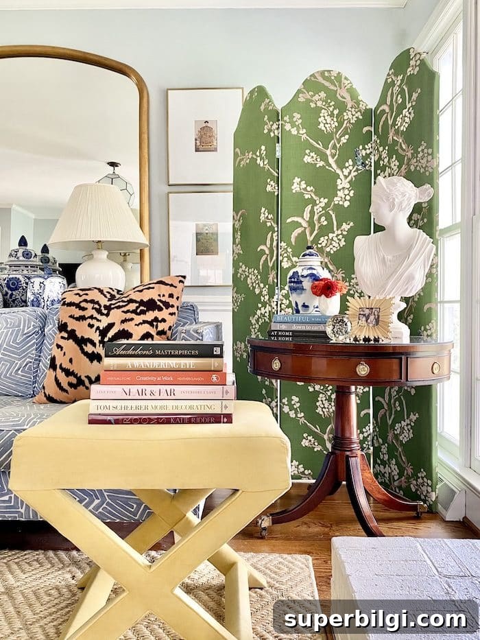 13 Creative Corner Decor Ideas to Transform Small Spaces 14 living room with a folding screen in the corner, a lady bust statue and a side table with books and other decor.
