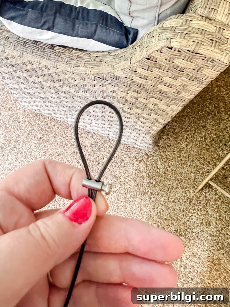 Hang Outdoor String Lights: DIY Patio and Backyard Tips 12 making a loop to hang string lights.