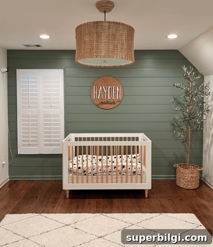 20 Nursery Paint Colors and Accent Wall Ideas for Baby Rooms 9 Boy's nursery with green shiplap walls and a modern white and wood crib.